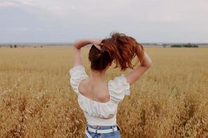 woman with red hair on nature in a field landscape unaltered photo