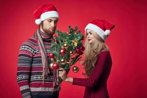 sad man and woman holiday dissatisfaction christmas red background photo