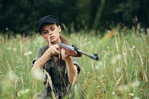 Woman on outdoor Shelter with a weapon in hand is a lifestyle photo