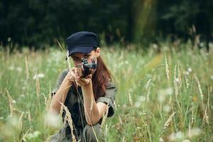 Military woman Hunting with weapons in hands on hiding places green leaves photo