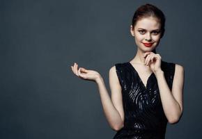 Woman shows her hands to the side on a gray background emotions advertising model photo