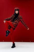 brunette in red leggings and hat plaid coat model indoor pose photo