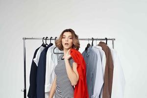 woman trying on a red shirt isolated background photo