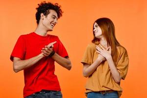 cheerful young couple lifestyle studio orange background cropped view photo