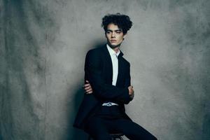 handsome guy curly hair suit self-confidence official photo