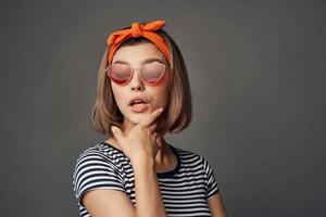 woman wearing sunglasses with orange bandage on head isolated background fashion photo