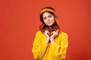 cheerful woman in yellow sweater hipster clothes studio fashion lifestyle photo