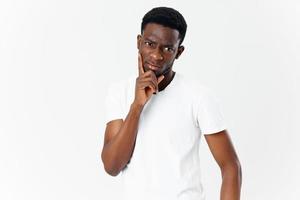 cute guy african appearance on a light background cropped view of a white t-shirt model photo
