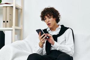 blogger sitting on a white sofa smartphone communication photo