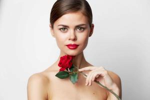 Woman with rose Bare shoulders, clear skin luxury light photo