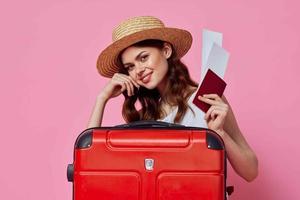 woman with passport and plane ticket red suitcase vacation passenger close-up photo