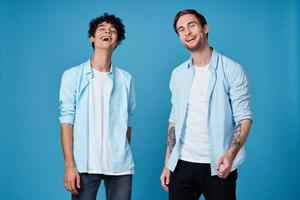 friends in identical clothes on blue background gesturing with hands cropped view photo