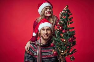 young couple christmas holiday fun romance red background photo