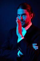 handsome man gestures with his hands attractive look neon light photo