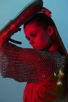 young woman red light silver armor chain mail fashion unaltered photo