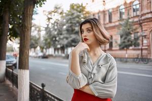 cute blonde girl with red lips outdoors walk near the building photo