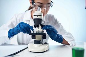 woman laboratory assistant microscope diagnostics research science photo