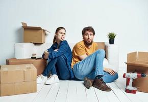 man and woman on the floor with boxes planning moving to apartment photo