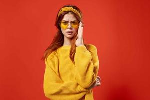 attractive woman in yellow sweater glasses fashion decoration studio photo