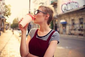 pretty woman outdoors wearing glasses glass with drink walk photo