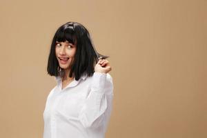 Pretty sexy beautiful stylish adorable brunet lady in white shirt posing isolated on pastel beige studio background. Copy space Banner Offer. Pulp Fiction concept. Fashion Cinema photo