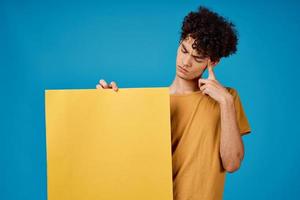 guy in yellow t-shirt poster mockup advertising blue background photo