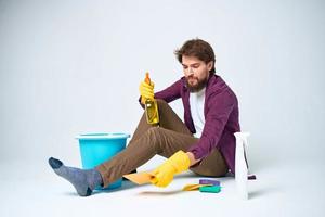 Man with detergent in the hands of a car wash providing housework hygiene services photo