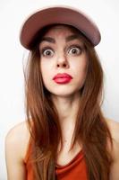 Emotional woman in a cap model with surprised expression fashionable clothes photo