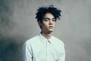 man with curly hair white shirt manager studio lifestyle photo