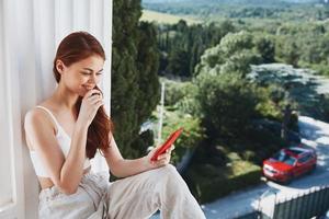 Portrait woman with long hair on an open balcony Green nature summer day Mountain View photo