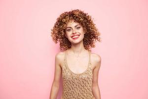 Model charming smile and sequin tank top fashion clothes pink background photo