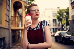 pretty woman with short hair outdoors walking in the city photo