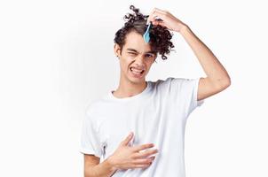 curly guy with comb in hair emotions cropped view photo