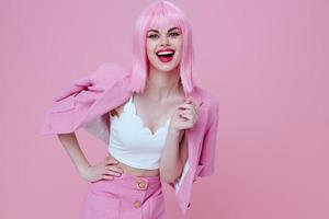 Portrait of a charming lady gestures with his hands with a pink jacket pink background unaltered photo