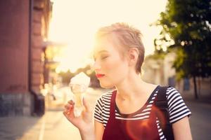 cute short haired woman outdoors eating ice cream fun photo