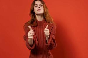 woman in red sweater fixing studio fashion lifestyle photo