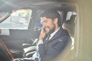 businessmen Driving a car trip luxury lifestyle communication by phone photo