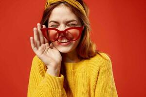 woman with yellow headband red glasses fashion yellow sweater photo