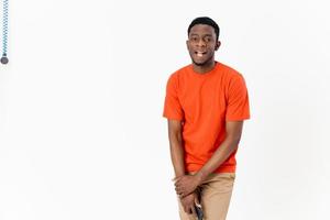 Cropped view of a cheerful African man with a mobile phone on a light background laughing photo