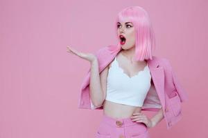 Pretty young female bright makeup pink hair glamor pink background unaltered photo