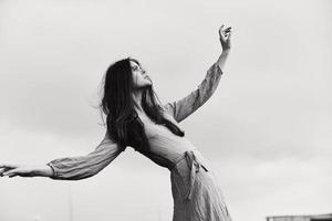 portrait of a beautiful woman in dress gesturing with hands posing unaltered photo