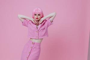 Portrait of a charming lady gestures with his hands with a pink jacket color background unaltered photo