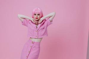 Portrait of a charming lady gestures with his hands with a pink jacket color background unaltered photo