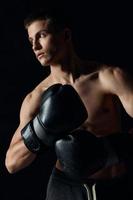 man wearing boxing gloves nude torso black background cropped view model fitness bodybuilder photo