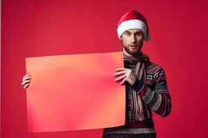 Cheerful man in New Year's clothes advertising copy space isolated background photo