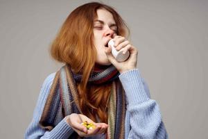 woman with a cold in a scarf health problems temperature medication photo