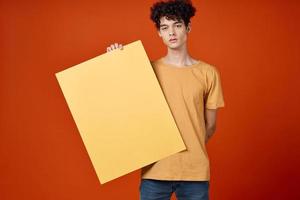 Cheerful guy with curly hair poster studio cropped view photo