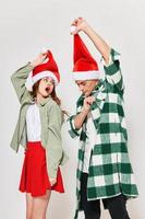 cheerful man and woman in Christmas hats holiday New Years relationship fun photo