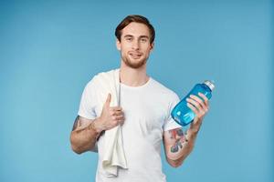 Cheerful man in white t-shirt workout water bottle energy photo