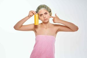 woman with pink towel nude ringlets cream skin care light background photo